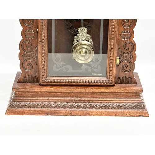 799 - A Late 19th Century American Gingerbread clock. Arsonia. With key and pendulum. 36x13x58cm