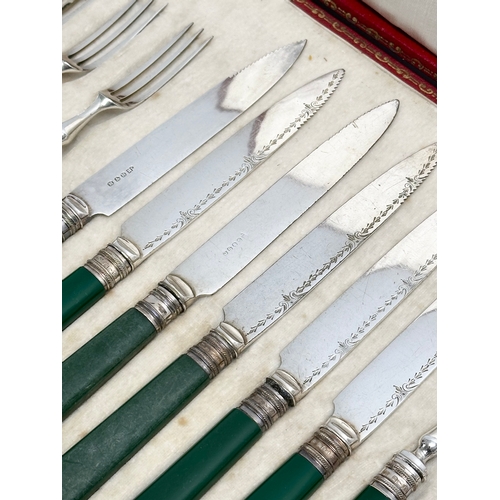 660 - George Howson. A set of Late 19th Century silver mounted fish forks and knives, in case. Retailed by... 