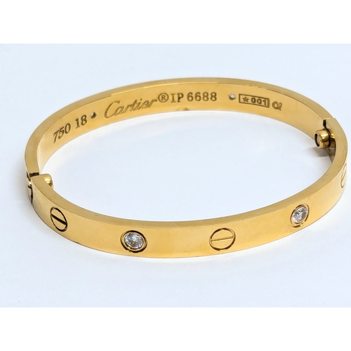 639 - An 18ct gold and diamond Cartier bangle in case.