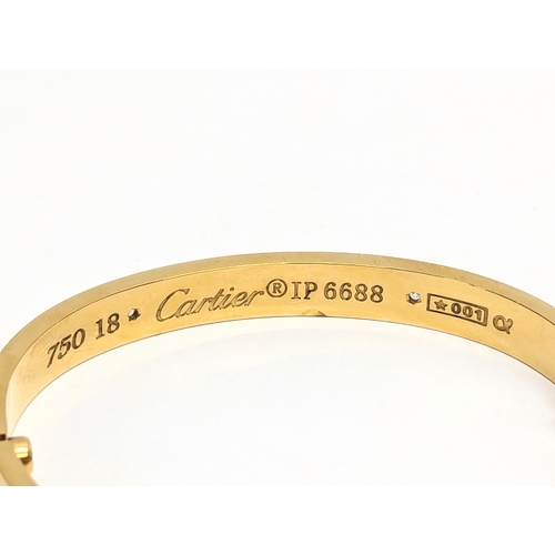 639 - An 18ct gold and diamond Cartier bangle in case.