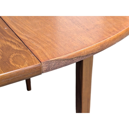 558 - A Mid Century teak extending dining table and 4 chairs. Closed 114.5x74.5cm. Open 145x114:5x74cm.(5)