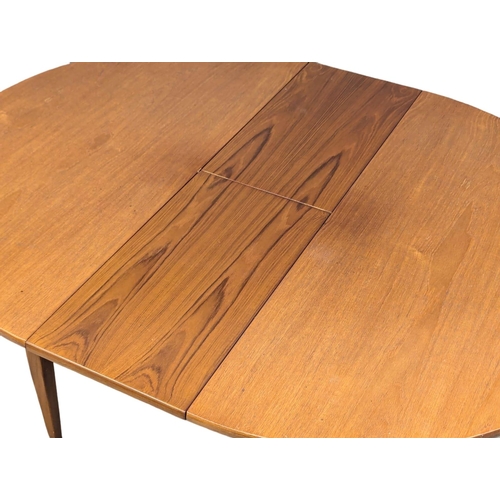 558 - A Mid Century teak extending dining table and 4 chairs. Closed 114.5x74.5cm. Open 145x114:5x74cm.(5)