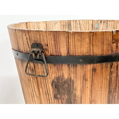 971 - A wooden barrel form planter. 46x32cm