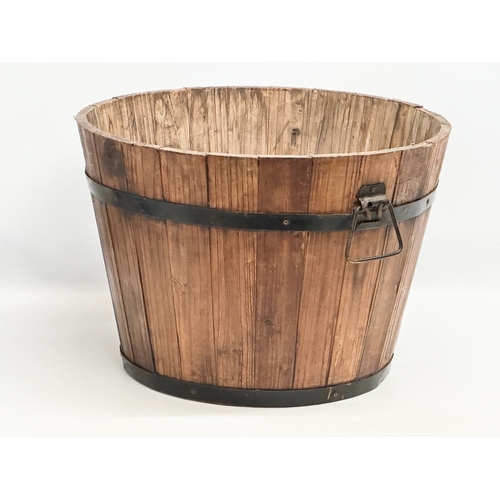 971 - A wooden barrel form planter. 46x32cm