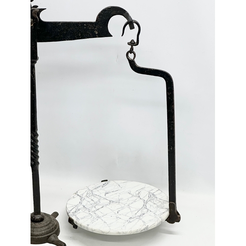 581A - A large Late 19th Century cast iron shops balance scales. 70x67cm