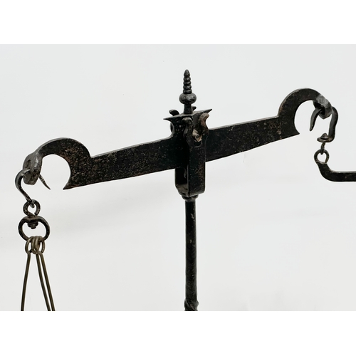 581A - A large Late 19th Century cast iron shops balance scales. 70x67cm