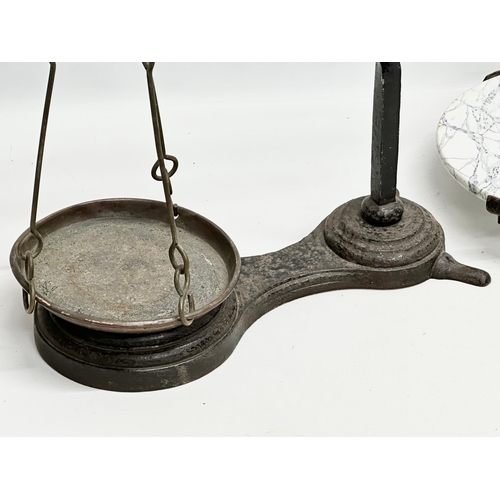 581A - A large Late 19th Century cast iron shops balance scales. 70x67cm