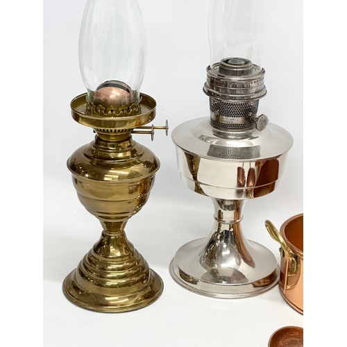 943 - A quantity of copper and oil lamps. An Aladdin oil lamp with other, Victorian style copper kettle, p... 