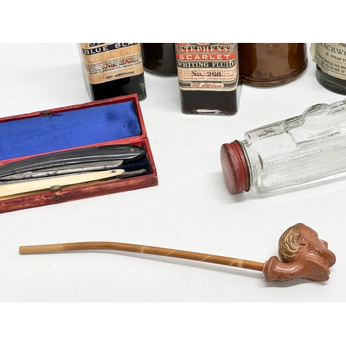 944 - A job lot of collectables. A Queen Mary glass bottle. A clay pipe with makers mark, cut throat razor... 