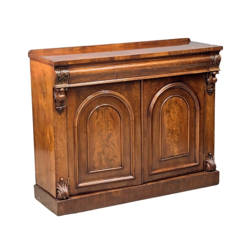 486 - A 19th Century Mid Victorian mahogany sideboard with large ogee drawer and 2 arched panel doors. 125... 