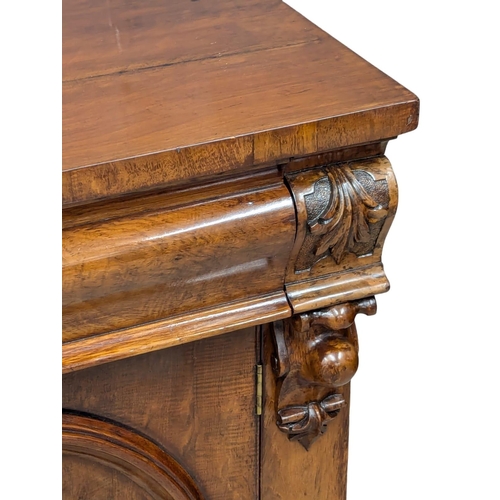 486 - A 19th Century Mid Victorian mahogany sideboard with large ogee drawer and 2 arched panel doors. 125... 