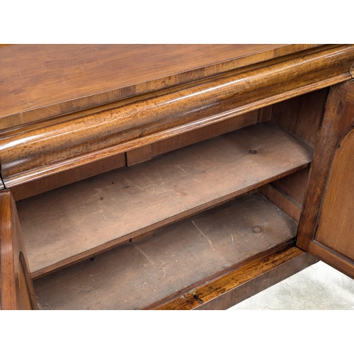 486 - A 19th Century Mid Victorian mahogany sideboard with large ogee drawer and 2 arched panel doors. 125... 