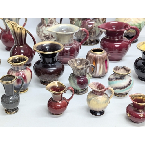 987 - A collection of German Mid Century style pottery jugs and vases. 20cm. 11cm. 7cm.