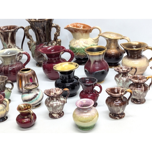 987 - A collection of German Mid Century style pottery jugs and vases. 20cm. 11cm. 7cm.