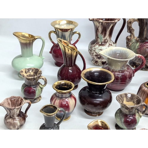 987 - A collection of German Mid Century style pottery jugs and vases. 20cm. 11cm. 7cm.