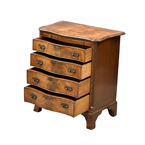 114 - An Early 20th Century Chippendale Revival mahogany serpentine front chest of drawers, with brushing ... 