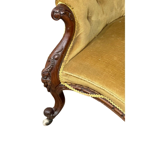 115 - A 19th Century Victorian walnut, deep button back double end couch/sofa. With carved frame and cabri... 