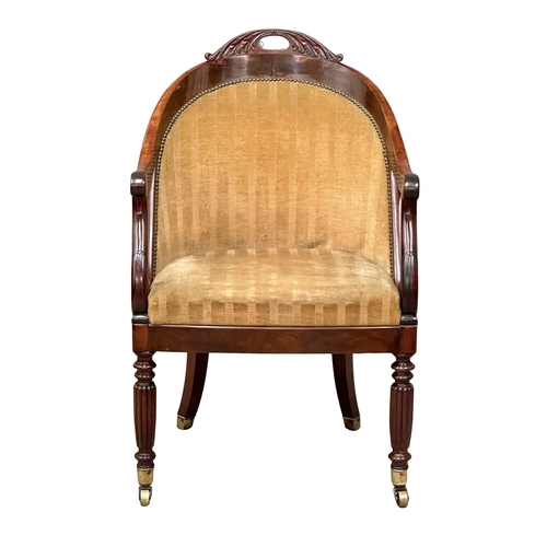 13 - An Early 19th Century Late George IV mahogany library chair/armchair, on reeded legs and brass cup c... 