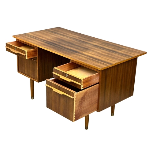 153 - A Mid Century afromosia desk. 130x69x74cm