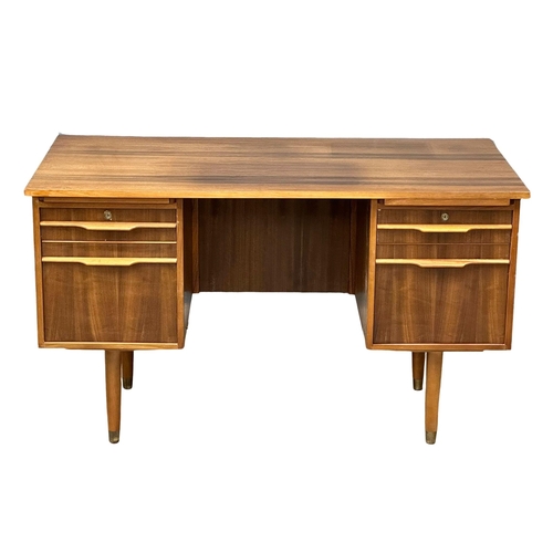 153 - A Mid Century afromosia desk. 130x69x74cm