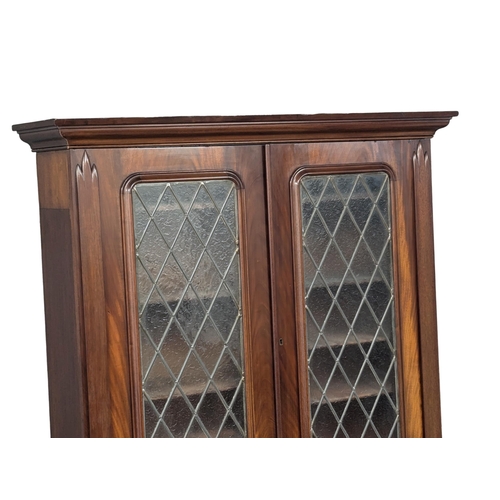 158 - A large 19th Century Victorian mahogany bookcase, with lead glass doors . 122x50x226cm