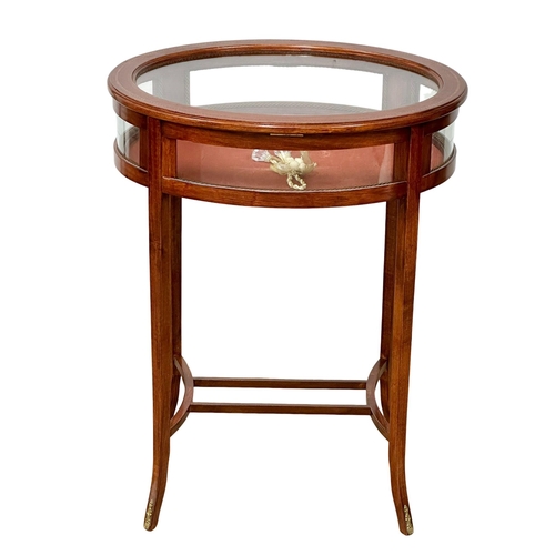 176 - An inlaid mahogany bijouterie table with brass mounts. Display table. 59x46x75cm