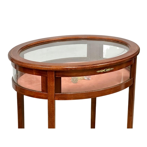 176 - An inlaid mahogany bijouterie table with brass mounts. Display table. 59x46x75cm