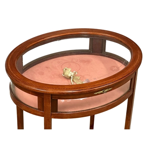 176 - An inlaid mahogany bijouterie table with brass mounts. Display table. 59x46x75cm