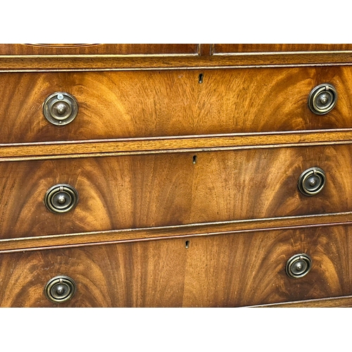 197 - A Regency style inlaid mahogany secretaire bookcase, with astragal glazed doors and splayed feet. 10... 