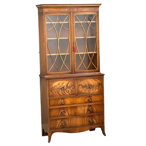 197 - A Regency style inlaid mahogany secretaire bookcase, with astragal glazed doors and splayed feet. 10... 