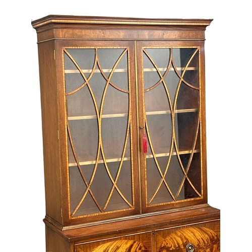 197 - A Regency style inlaid mahogany secretaire bookcase, with astragal glazed doors and splayed feet. 10... 