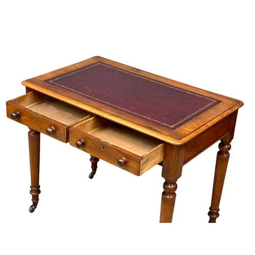 221 - A 19th Century Victorian mahogany writing table, with 2 drawers, leather top and turned legs. Circa ... 