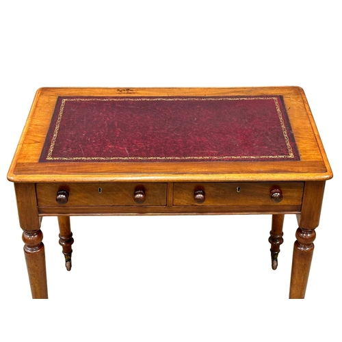 221 - A 19th Century Victorian mahogany writing table, with 2 drawers, leather top and turned legs. Circa ... 