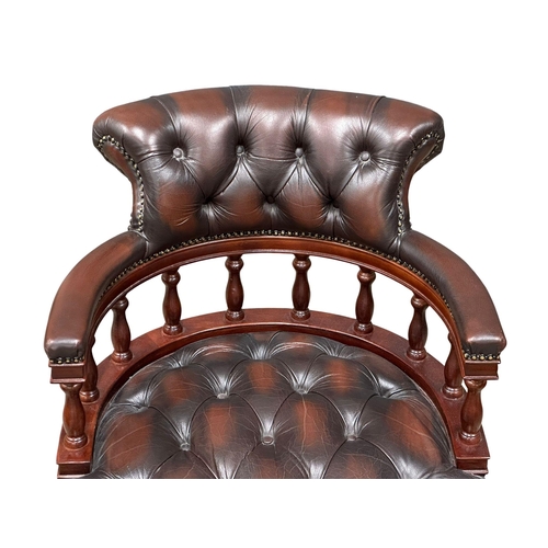 222 - A deep button leather swivel desk chair.