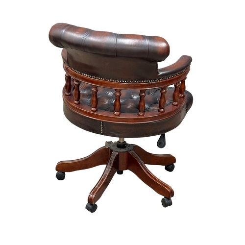 222 - A deep button leather swivel desk chair.