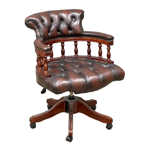 222 - A deep button leather swivel desk chair.