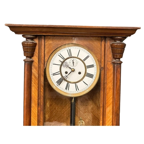 225 - A 19th Century Victorian mahogany Vienna wall clock, with 2 weights, pendulum and key. 49x93cm.