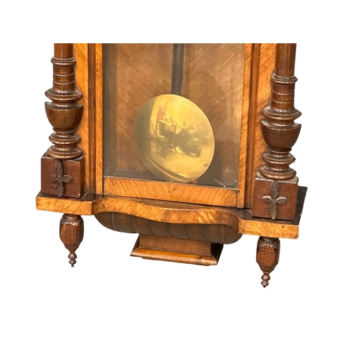 225 - A 19th Century Victorian mahogany Vienna wall clock, with 2 weights, pendulum and key. 49x93cm.