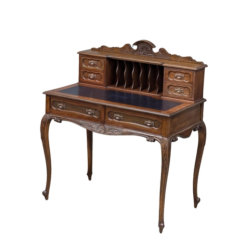 259 - A Late 19th Century mahogany ladies writing desk with 2 front drawers and cabriole legs. Circa 1890.... 