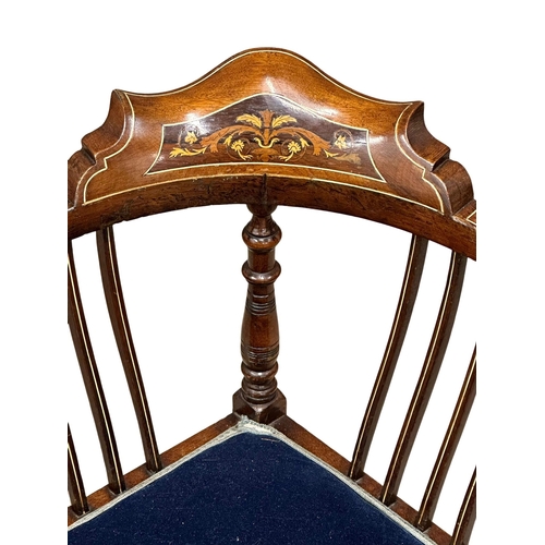 295 - A Late Victorian inlaid corner armchair. Circa 1900. Made in mahogany, rosewood and beech.