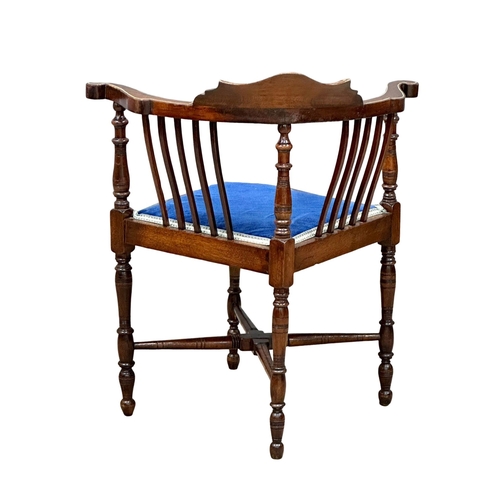 295 - A Late Victorian inlaid corner armchair. Circa 1900. Made in mahogany, rosewood and beech.