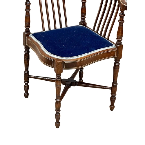 295 - A Late Victorian inlaid corner armchair. Circa 1900. Made in mahogany, rosewood and beech.