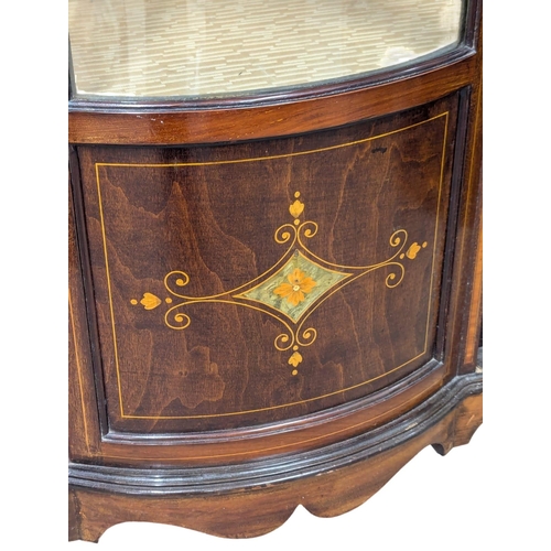 312 - An Edwardian inlaid mahogany display cabinet with bow front panel. 109x34x174cm. (5)