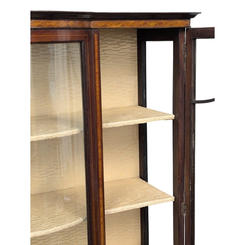 312 - An Edwardian inlaid mahogany display cabinet with bow front panel. 109x34x174cm. (5)