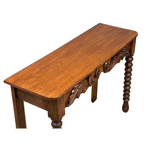 318 - A 19th Century Victorian mahogany side table with barley twist supports. 117x39x79cm