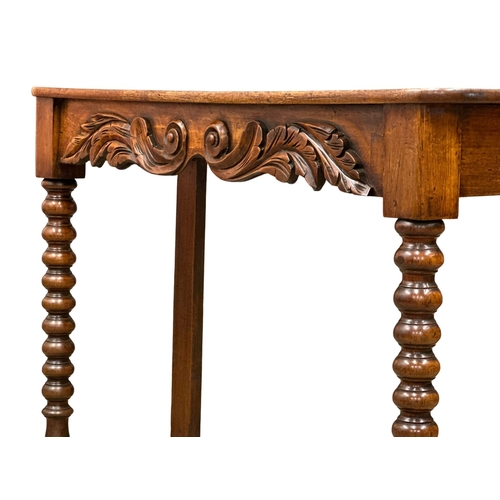 318 - A 19th Century Victorian mahogany side table with barley twist supports. 117x39x79cm