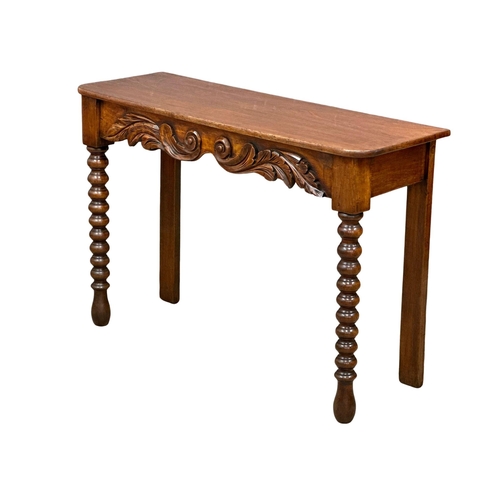 318 - A 19th Century Victorian mahogany side table with barley twist supports. 117x39x79cm