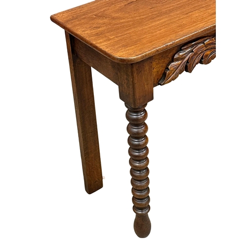 318 - A 19th Century Victorian mahogany side table with barley twist supports. 117x39x79cm