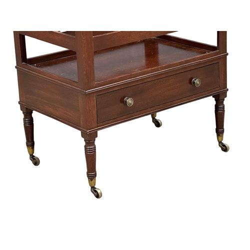 320 - A George IV mahogany Canterbury with drawer and brass cup casters. Circa 1820.