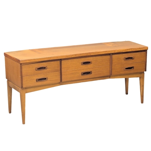 341 - Frank Guille. A Mid Century teak sideboard designed by Frank Guille for Austinsuite. 153x44x66.5cm